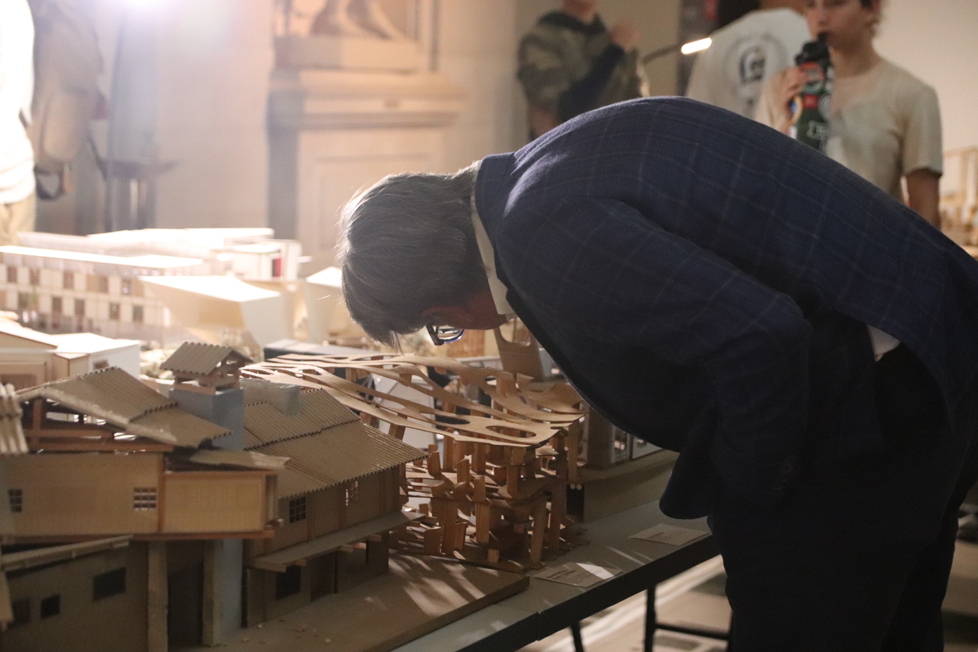 a person looks at a model on a table