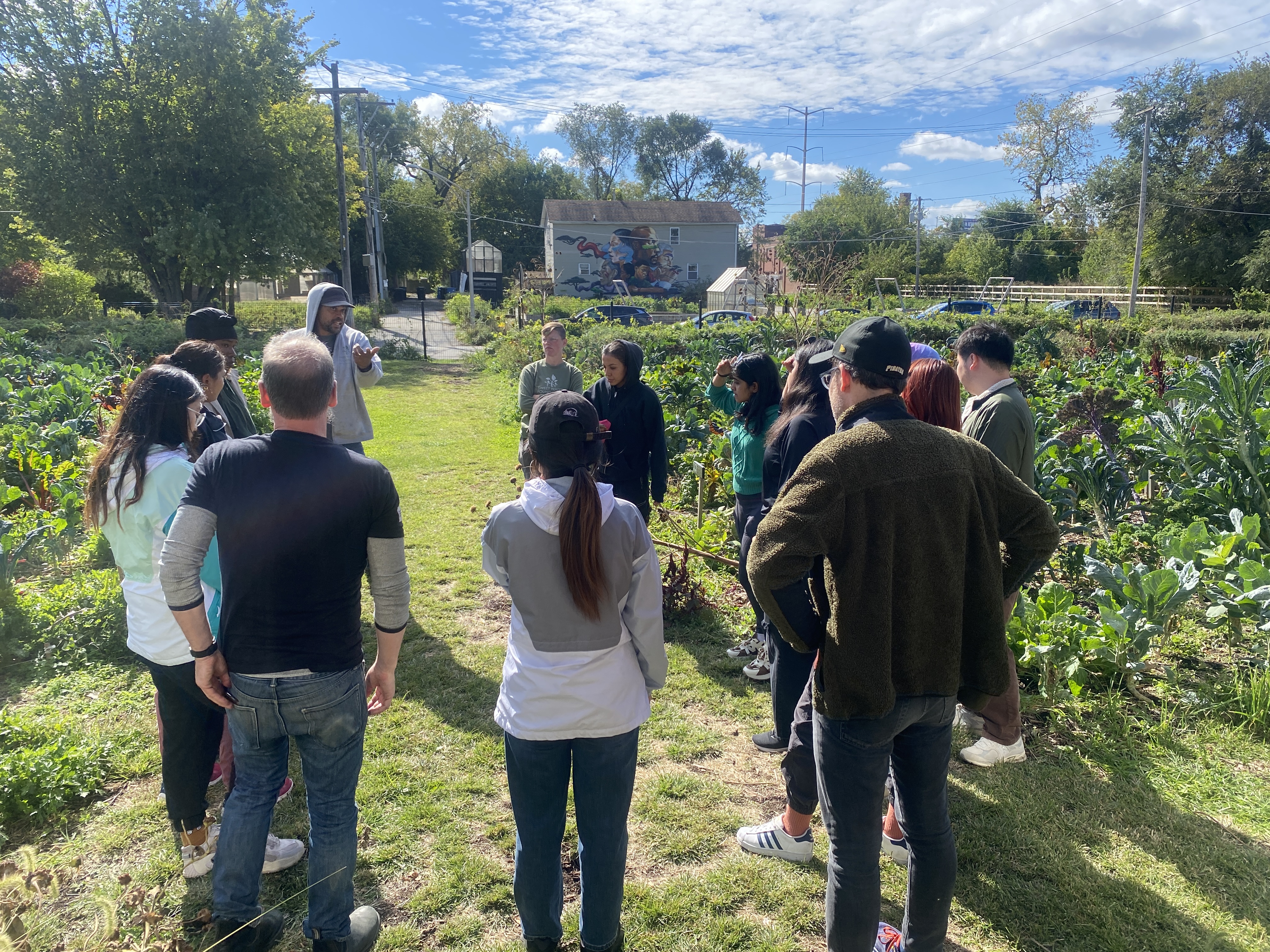 group of people gathered outside in a garden