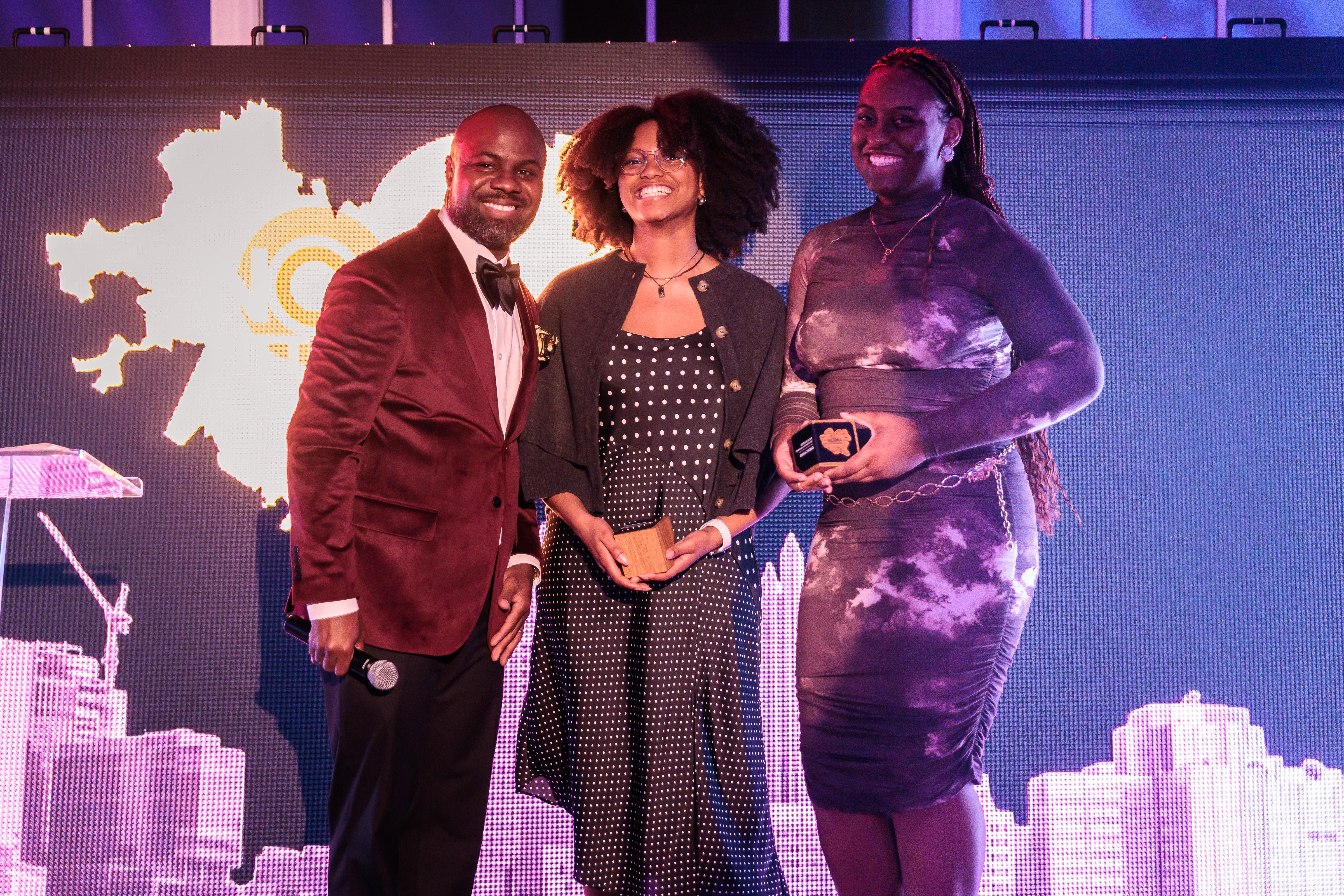 Starr Wasler and Shayla Thomas receive awards onstage at NOMA gala