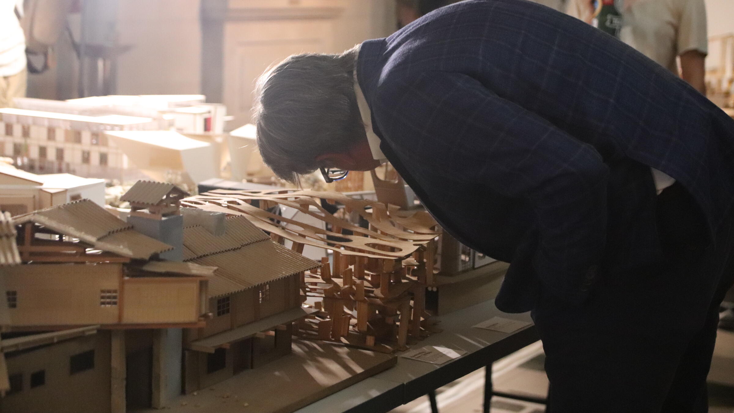 a person looks at a model on a table