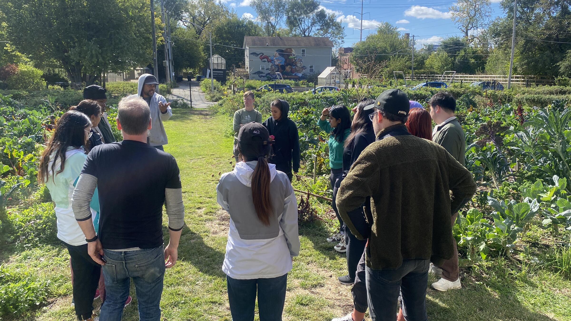 group of people gathered outside in a garden