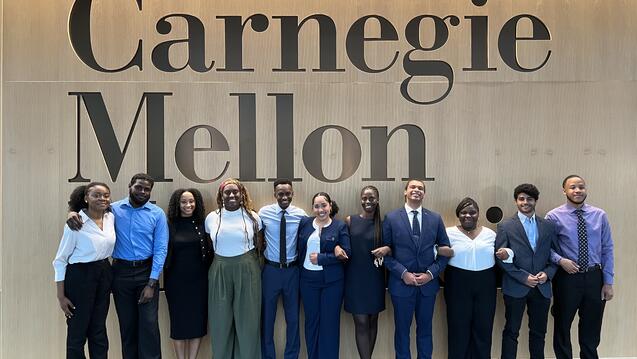 a group of UDream participants in front of a wall with Carnegie Mellon written on it