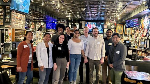 Alumni pose with head of school Omar Khan (right) during an alumni event in Seattle.