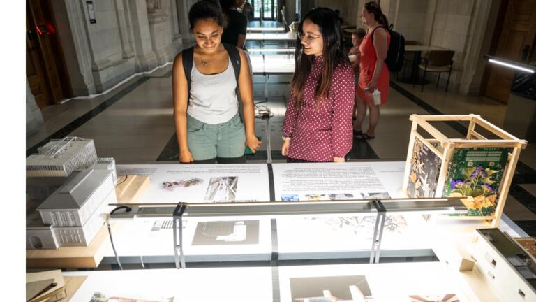 students look at the 2024 EX-CHANGE exhibition in the CFA Great Hall