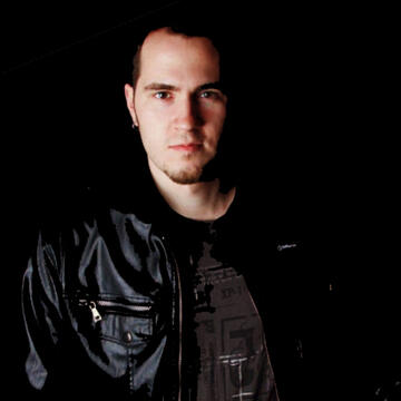 person in a black leather jacket and black t-shirt on a black background