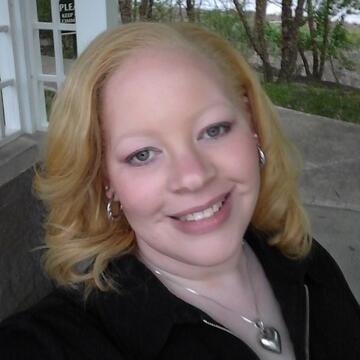 person with blonde hair and black top on a porch