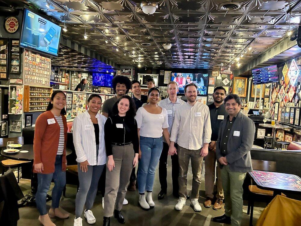 Alumni pose with head of school Omar Khan (right) during an alumni event in Seattle.