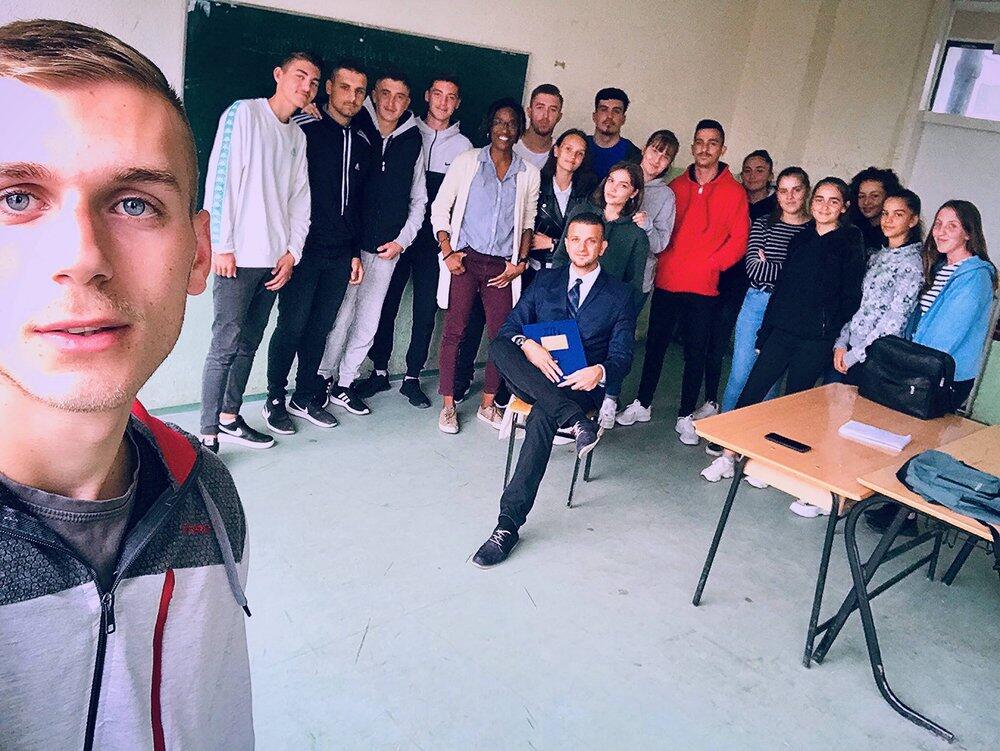 Ashley Archie (middle) poses with students at a speaking engagement in Kosovo. Image courtesy of Ashley Archie.